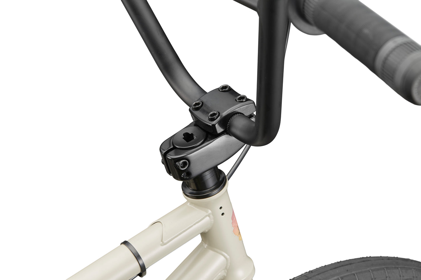 Close-up of BLVD bike’s black handlebars and stem on a cream frame, showing balanced geometry for all-around performance.