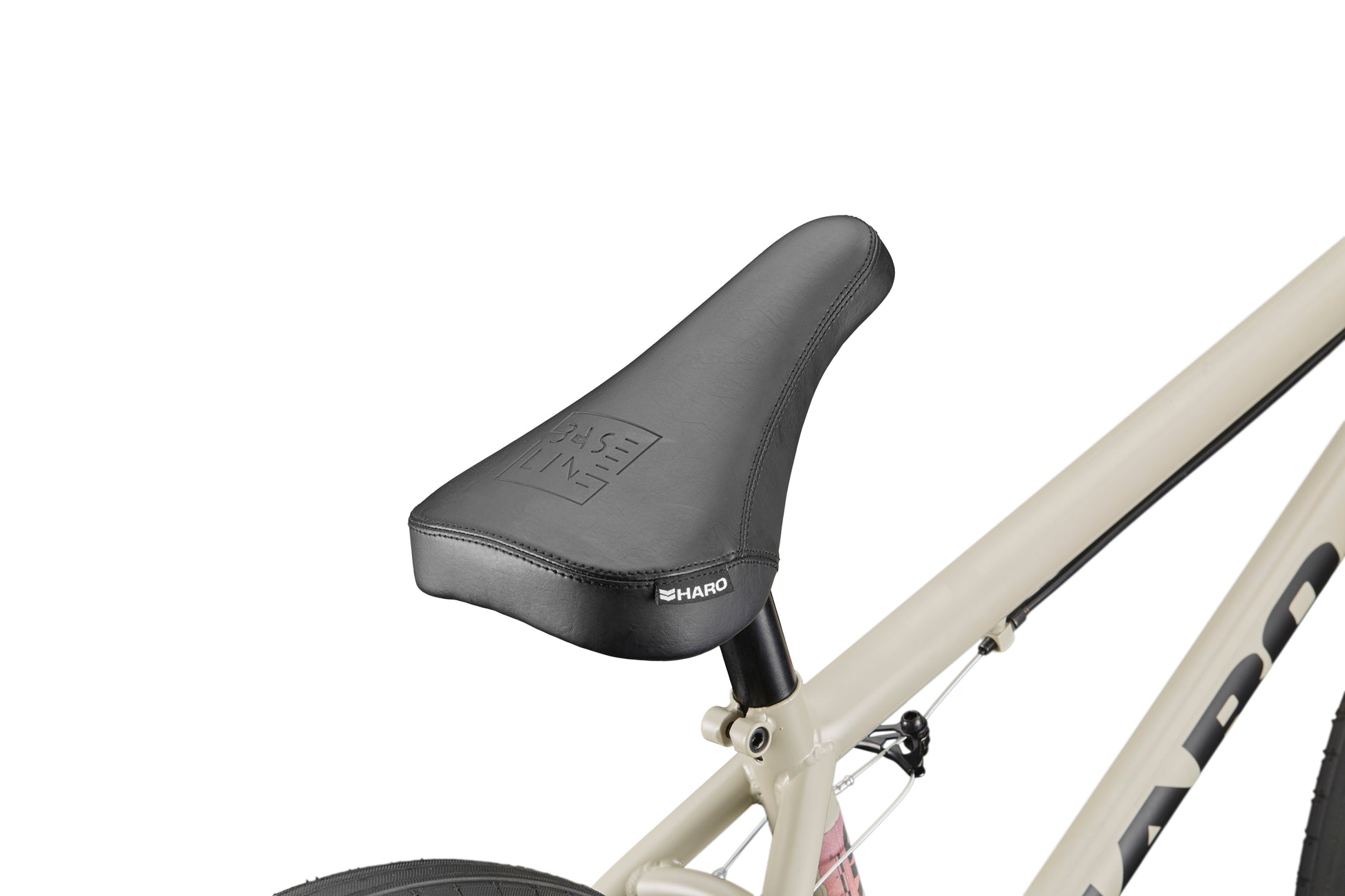 Side view of a black bicycle seat on a beige Haro BLVD frame, highlighting performance and part of the rear wheel.