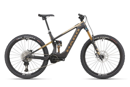 The eDaley Carbon Top Shelf is a black and gold mountain bike with thick tires, carbon frame, and full suspension for a lightweight ride.