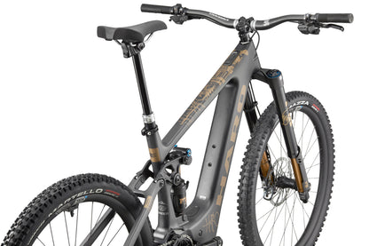 The eGreer Carbon Top Shelf is a matte gray, full-suspension carbon ebike with black and gold details, shown from the rear-left angle.