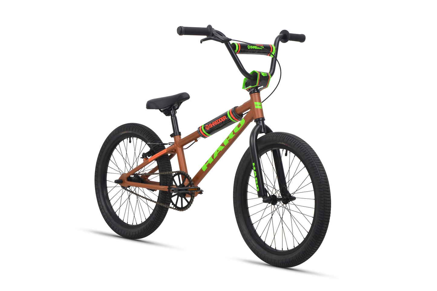 The Shredder 20 BMX bike features a brown alloy frame with green accents, black seat, and black tires.