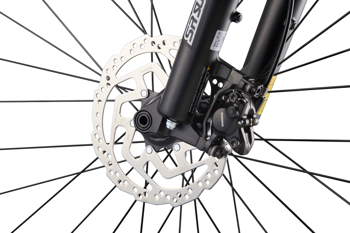 Close-up of Double Peak’s front hydraulic disc brake, rotor, black spokes, and fork, highlighting its mechanical details.