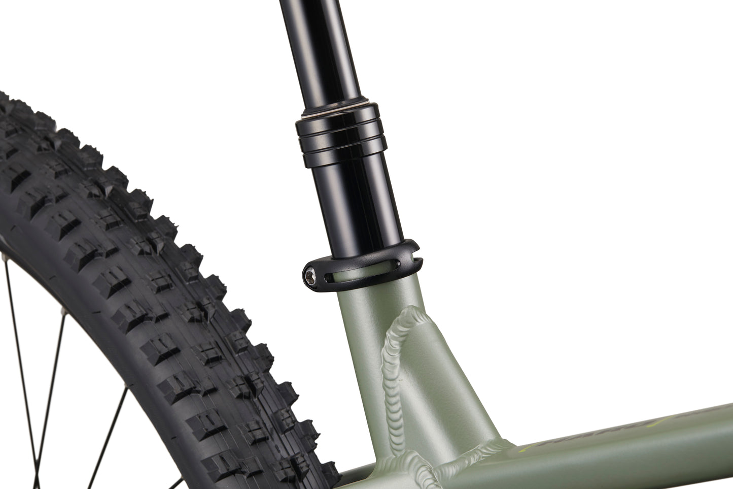 Close-up of Double Peak’s rear tire, seatpost, frame with visible welds, 148 boost spacing, and seatpost clamp.