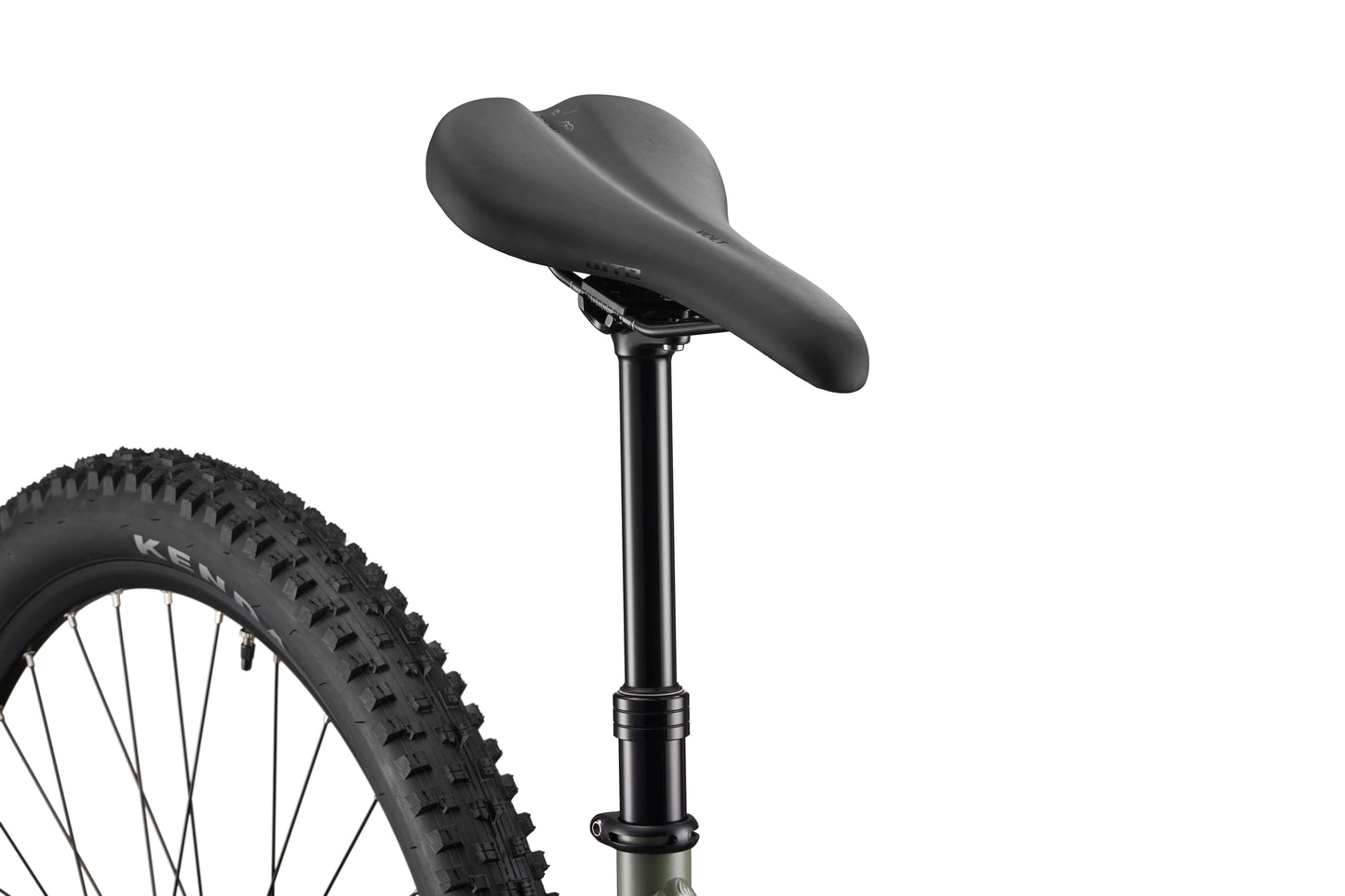 Close-up of Double Peak’s black seat and dropper post, with rear wheel and tire partially visible against a white background.