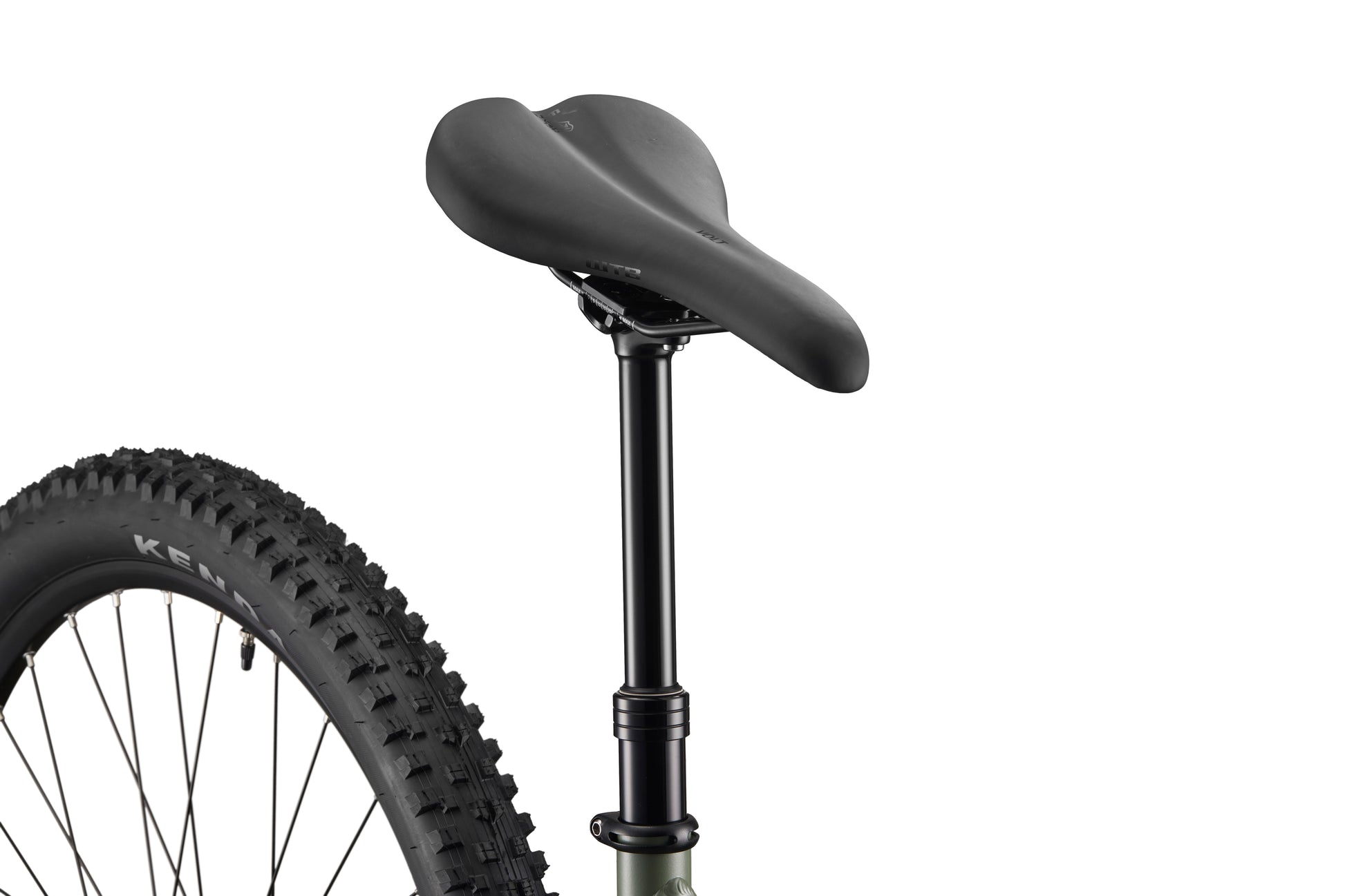 Close-up of Double Peak’s black seat and dropper post, with rear wheel and tire partially visible against a white background.