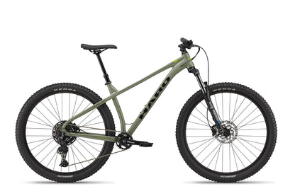 The Double Peak mountain bike, shown side view on white, has thick tires, hydraulic disc brakes, and a black saddle.