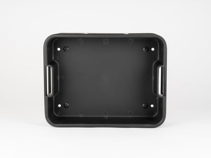 The Atran Velo Bakery Crate, a sleek black rectangular non-stick baking pan with cargo-style design, features two metal handles on both sides. Its viewed from above against a plain white background.