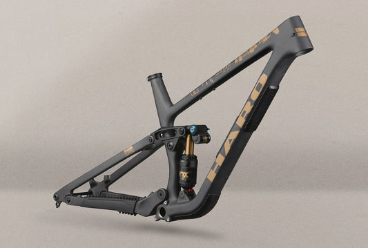 Greer Carbon Frameset in matte black with gold HARO logos, pictured with a FOX FLOAT X2 Factory rear shock on a plain backdrop.