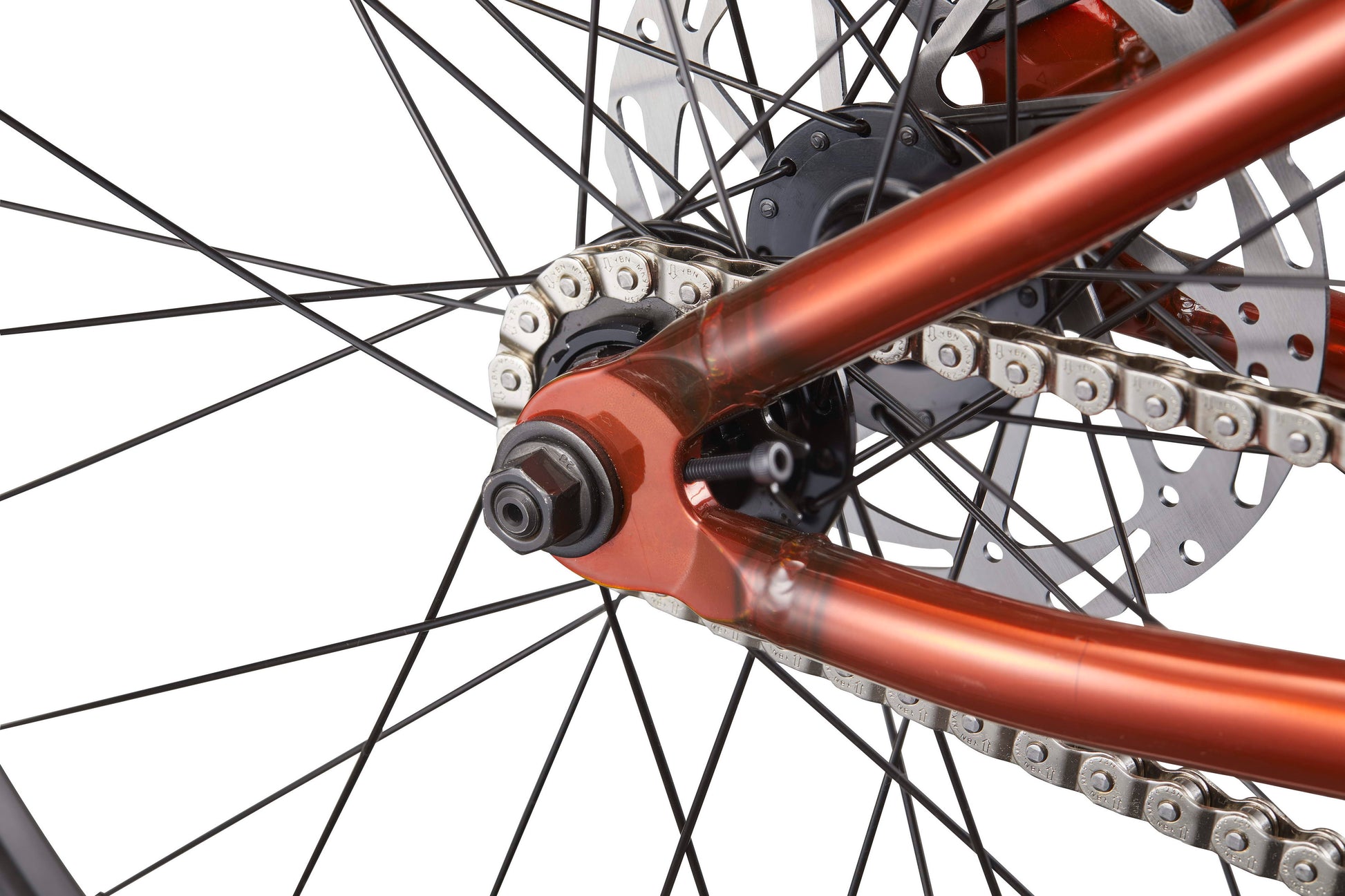 Close-up of the Steel Reserve’s rear wheel, highlighting its chromoly frame, chain, spokes, and disc brake against white.