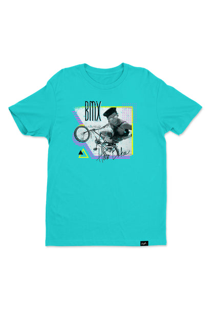 The Windy Osborn Stubbleduck Shirt by Haro Bikes features a graphic design of a BMX biker mid-trick on turquoise fine jersey cotton. It showcases geometric shapes with BMX at the top, complemented by a Crew Neck and signature-like text for added style.