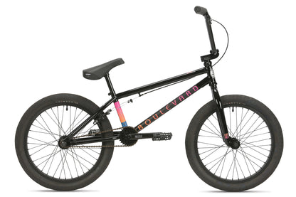 The Haro Bikes Boulevard 20.5, a black BMX bike with vibrant decals, embodies the BMX lifestyle with its durable frame, wide tires, and single gear. The seat tilts slightly upward while the handlebars angle back for optimal control.