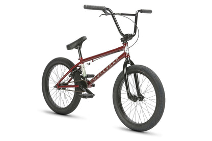 The Haro Bikes Boulevard 20.5 BMX bike features a maroon and black frame, black handlebars, and wheels on a white background. Designed for stunts and park riding, it comes with knobby tires and a padded seat for comfort.