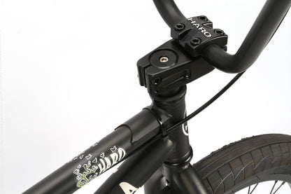 Close-up of Haro Bikes Leucadia BMX handlebars and front stem, ideal for catching air at the skatepark. HARO is visible on the sleek handlebar stem, with decorative graphics on the bike frame against a plain white background.