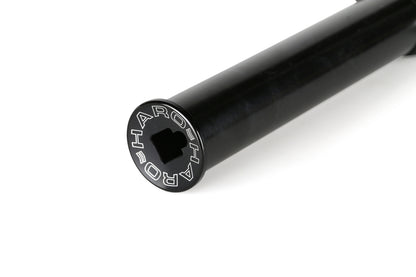 A close-up of a black metal peg on the Baseline Fork by Haro Bikes reveals HARO engraved on its circular end. Made from durable chromoly, it features a hollow square opening for 3/8 dropouts, with an elegant light-reflecting smooth surface.