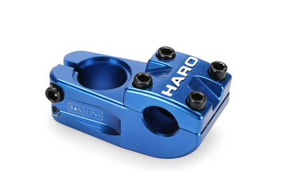 The blue Baseline Top Load CNC Stem by Haro Bikes features Haro on top, four black bolts, and a sleek, modern design. Expertly crafted from 6061 aluminum, its shiny surface enhances its stylish appearance.