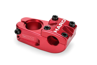 Close-up of a red Haro Bikes Baseline Top Load CNC stem made from 6061 aluminum, featuring multiple bolt holes and HARO printed on it with a sleek, CNC-machined design.